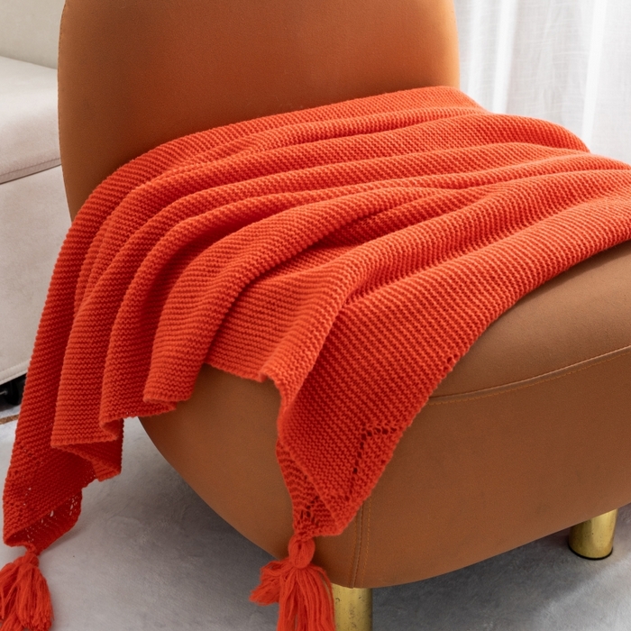 91家纺网 家纺一手货源 找家纺 肖恩毯业 2025新款鹿毛绒针织毯纯色素色螺纹镂空苏头北欧毛毯复古沙发毯休闲毯子 暗橘色