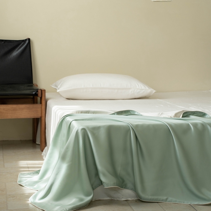 91家纺网 家纺一手货源 找家纺 沐晴家纺 2025新款60纯色兰精天丝休闲盖毯嵌绳工艺天丝毯-风格一 绿野仙踪