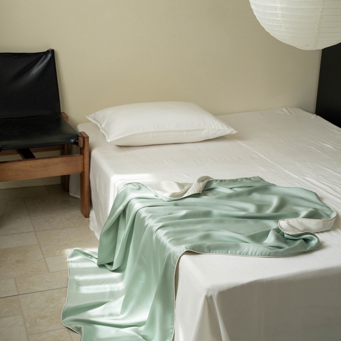 91家纺网 家纺一手货源 找家纺 沐晴家纺 2025新款60纯色兰精天丝休闲盖毯嵌绳工艺天丝毯-风格一 绿野仙踪