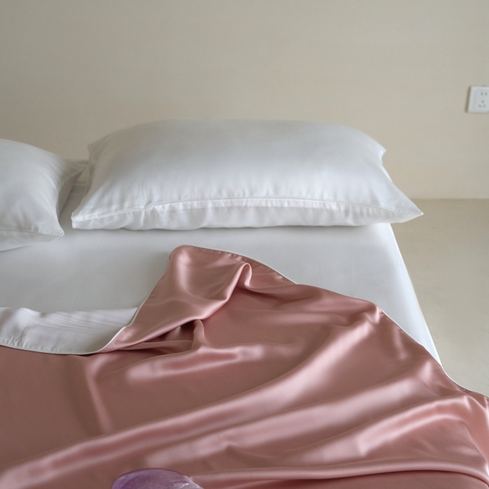 91家纺网 家纺一手货源 找家纺 沐晴家纺 2025新款60纯色兰精天丝休闲盖毯嵌绳工艺天丝毯-风格二 桃之夭夭