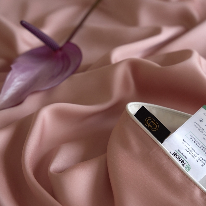 91家纺网 家纺一手货源 找家纺 沐晴家纺 2025新款60纯色兰精天丝休闲盖毯嵌绳工艺天丝毯-风格二 桃之夭夭