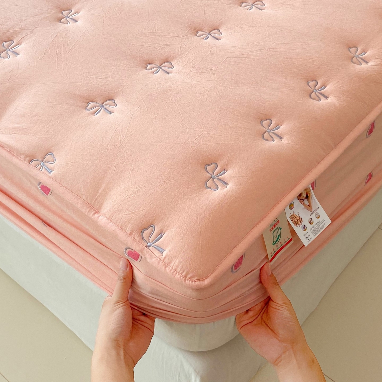 91家纺网 家纺一手货源 找家纺 尊康家纺（原磊科） 2025新款7A抗菌全棉色织水洗棉大豆棉填充床笠-同心结 同心结-粉玉