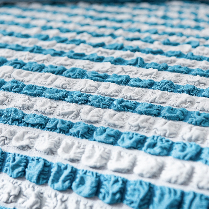 91家纺网 家纺一手货源 找家纺 布兰鸟【沙发套】 2025新款泡泡沙发套【英文裙摆款】单人沙发风格 双色蓝