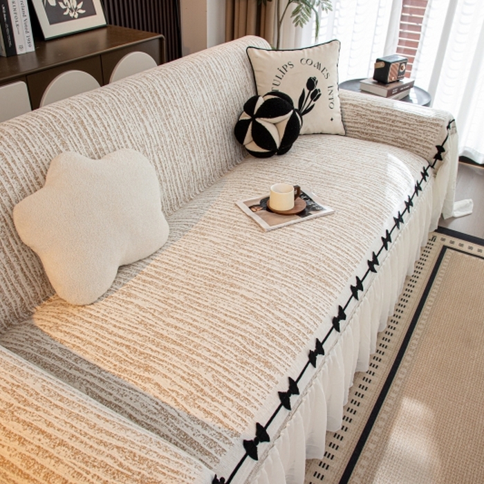 91家纺网 家纺一手货源 找家纺 沐沐家纺 2026新款宛柔蝴蝶结裙边沙发巾 驼色