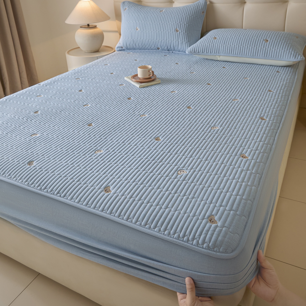 91家纺网 家纺一手货源 找家纺 卡伦家纺 2025新品全棉色织水洗棉刺绣夹棉床笠席梦思保护套小熊系列 雾蓝熊