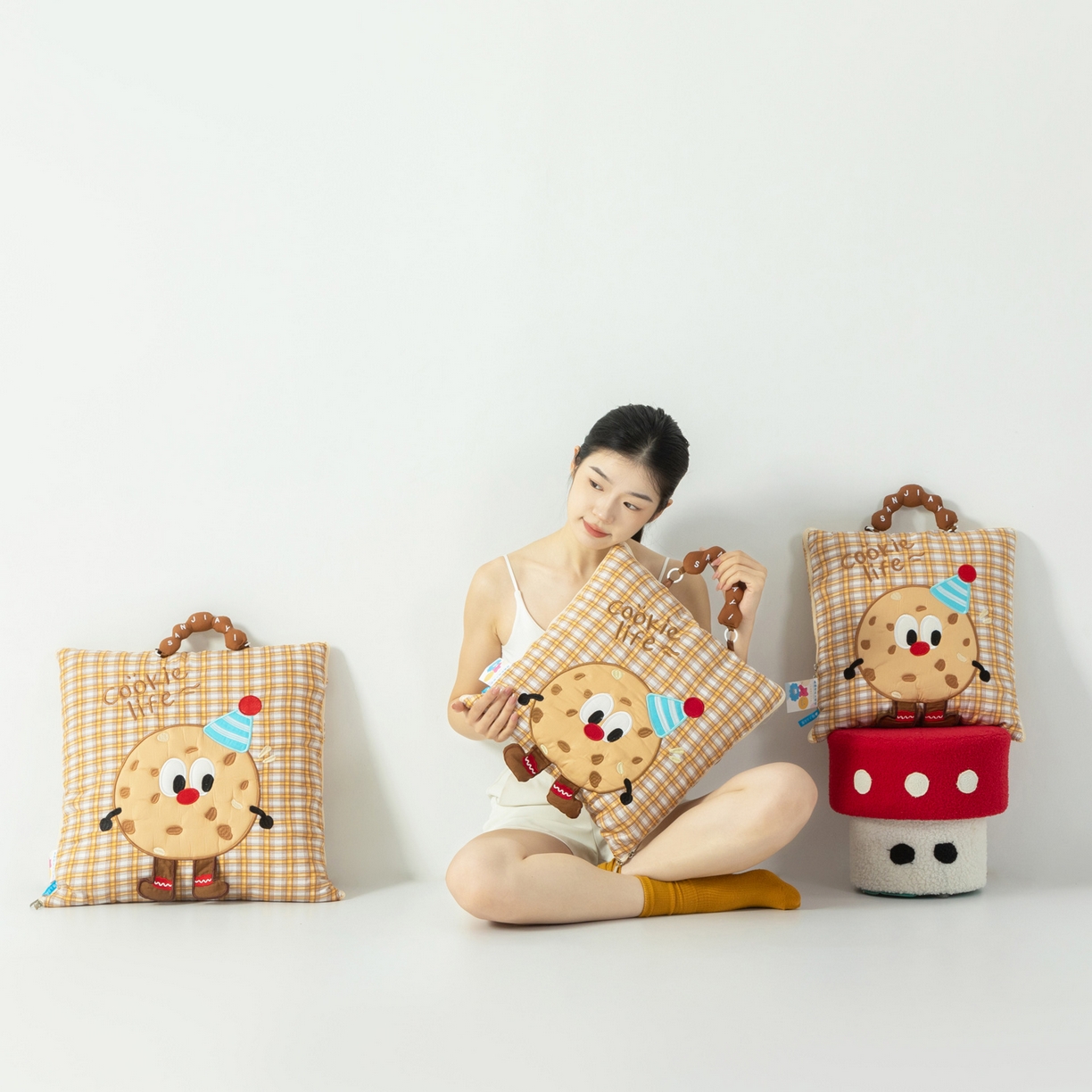 91家纺网 家纺一手货源 找家纺 雷娜家居 2026新款水洗棉手提款曲奇抱枕被 水洗棉饼干卡其