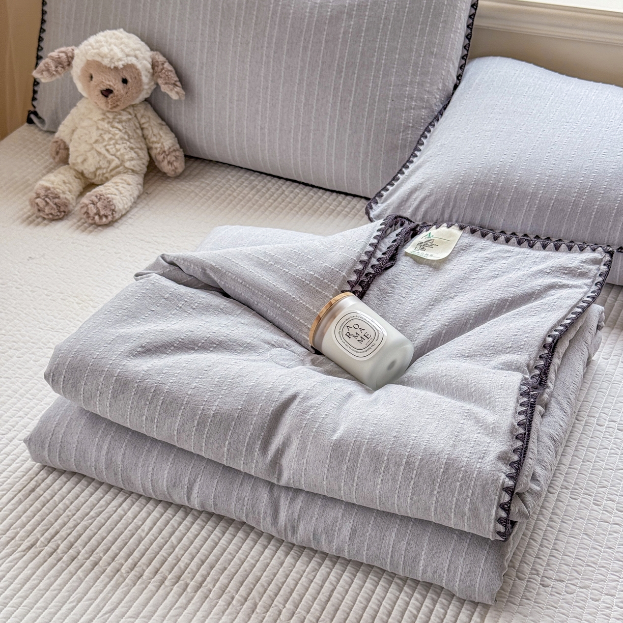 91家纺网 家纺一手货源 找家纺 鑫利来家纺 2026新款纯色无印风夏被简约素色法式麻夏凉被阳离子色织提花单人双人学生夏凉被-场景二 青禾-浅灰