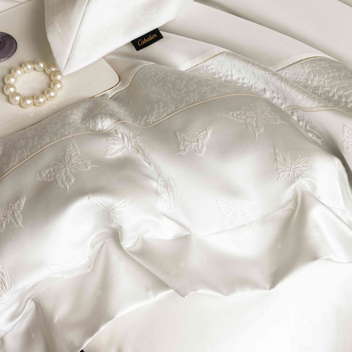 91家纺网 家纺一手货源 找家纺 卡巴伦家纺 2026春夏新款全棉纯棉贡缎高精密提花边条款式四件套 琉璃福蝶-白