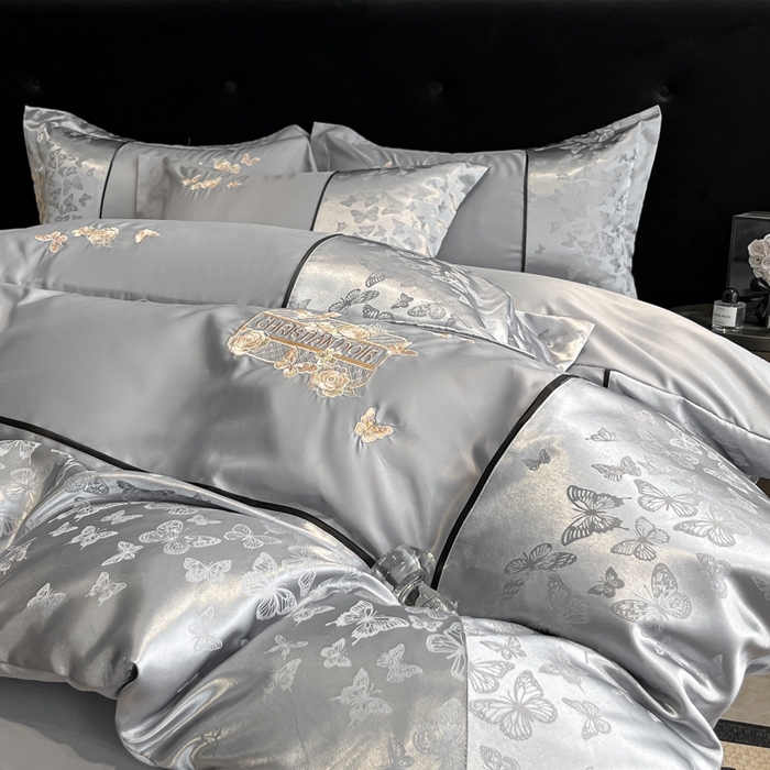 91家纺网 家纺一手货源 找家纺 金牛座家纺 2026新款金牛座细斜纹贡缎亮丝提花大拼角刺绣床盖四件套-缇娜系列 缇娜-灰